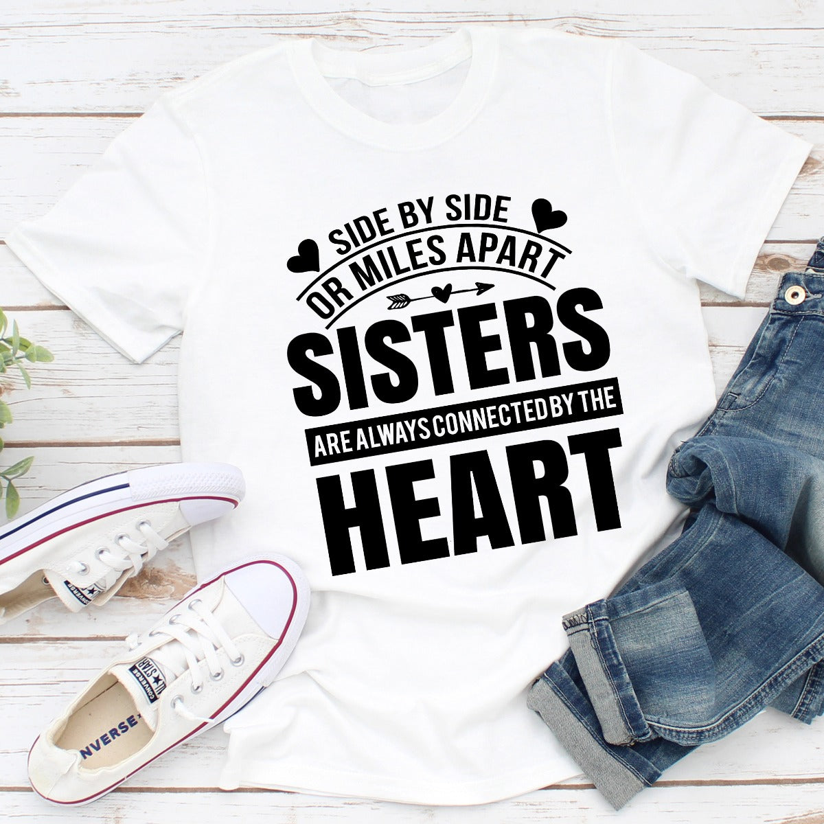A soft, durable t-shirt featuring the phrase 'Side By Side Or Miles Apart Sisters Are Always Connected By The Heart' in a stylish font.