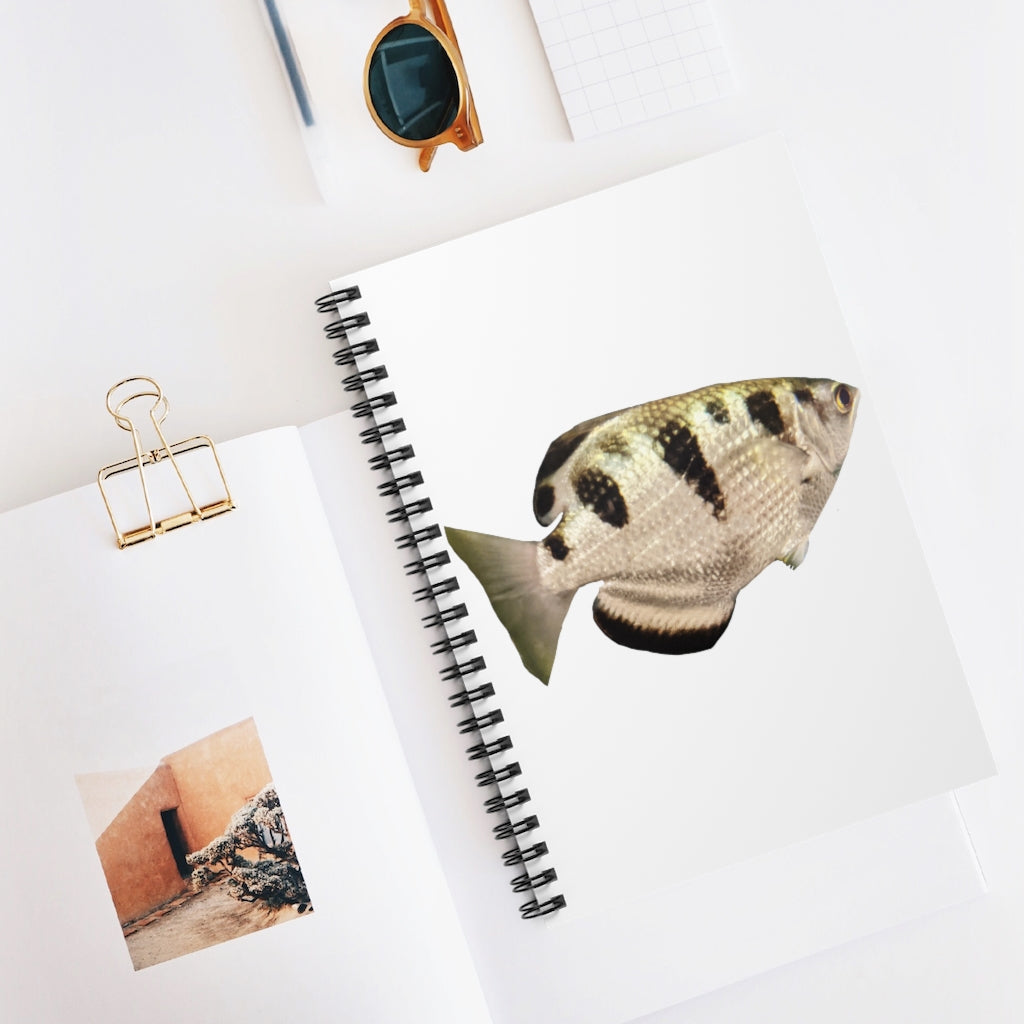 Silver and black spiral notebook featuring a fish design on the front cover, with ruled line pages inside.