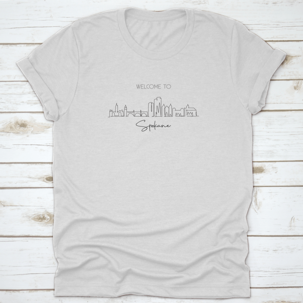A stylish t-shirt featuring a single continuous line drawing of the Spokane city skyline, showcasing its unique architectural features.