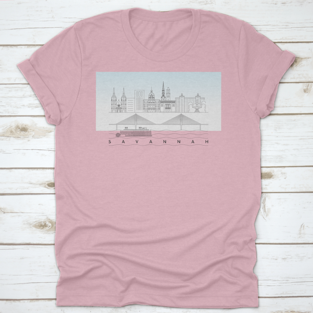 A stylish t-shirt featuring a sketch of Savannah, Georgia's skyline with a food stand and sandy beach, showcasing vibrant colors and artistic details.