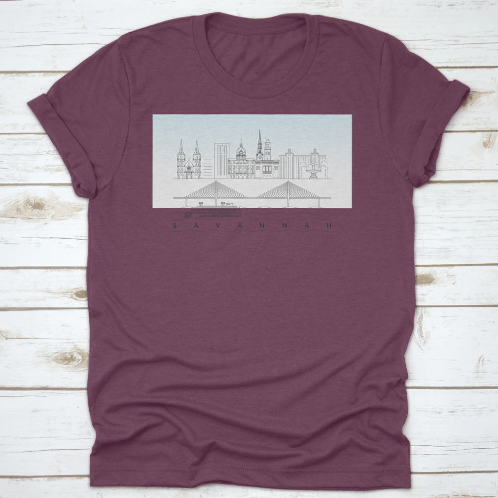A stylish t-shirt featuring a sketch of Savannah, Georgia's skyline with a food stand and sandy beach, showcasing vibrant colors and artistic details.