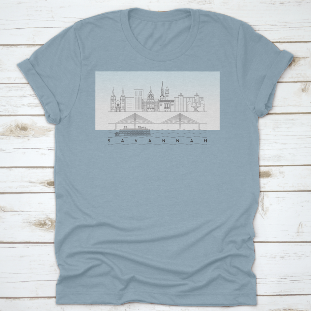 A stylish t-shirt featuring a sketch of Savannah, Georgia's skyline with a food stand and sandy beach, showcasing vibrant colors and artistic details.