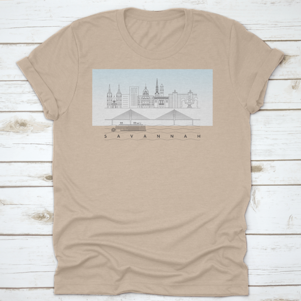 A stylish t-shirt featuring a sketch of Savannah, Georgia's skyline with a food stand and sandy beach, showcasing vibrant colors and artistic details.