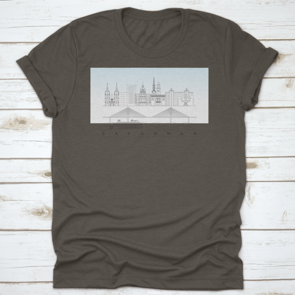 A stylish t-shirt featuring a sketch of Savannah, Georgia's skyline with a food stand and sandy beach, showcasing vibrant colors and artistic details.