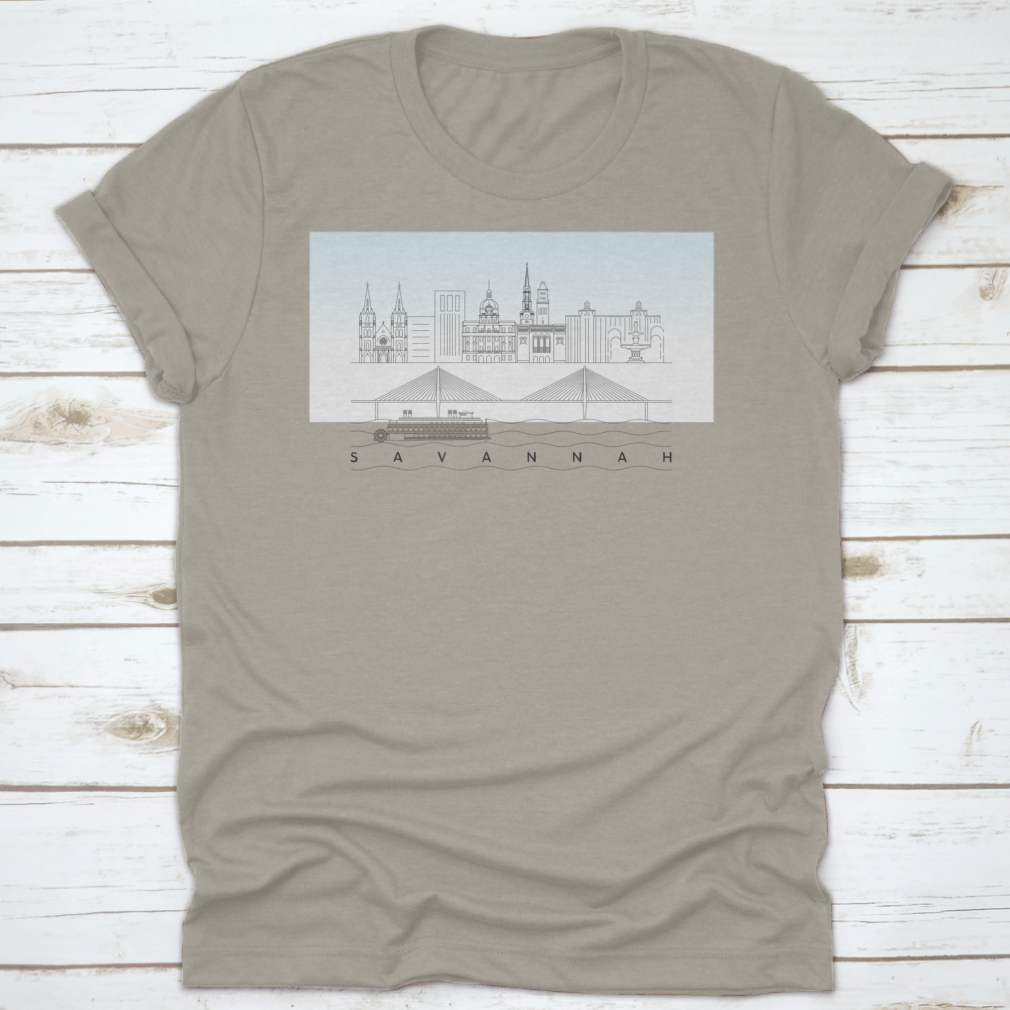 A stylish t-shirt featuring a sketch of Savannah, Georgia's skyline with a food stand and sandy beach, showcasing vibrant colors and artistic details.