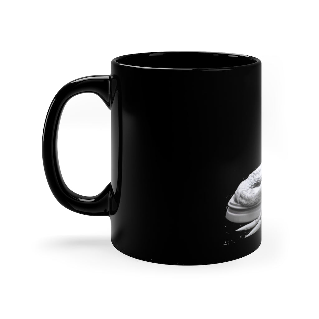 A sleek black ceramic mug with a C-handle, perfect for coffee, tea, or hot chocolate, showcasing its 11oz capacity.