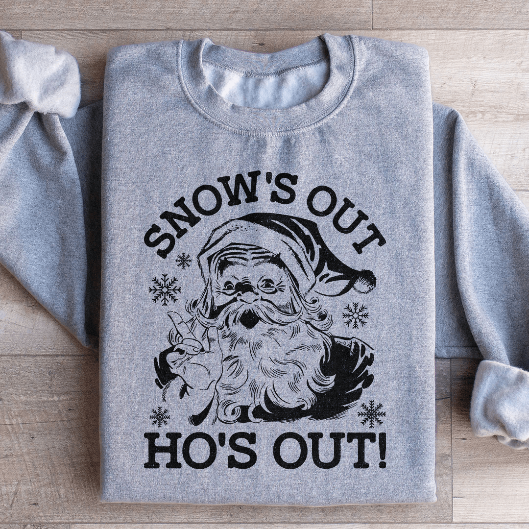 A festive Snow's Out Ho's Out Sweatshirt featuring a vibrant holiday design, made from 100% soft cotton, perfect for Christmas celebrations.