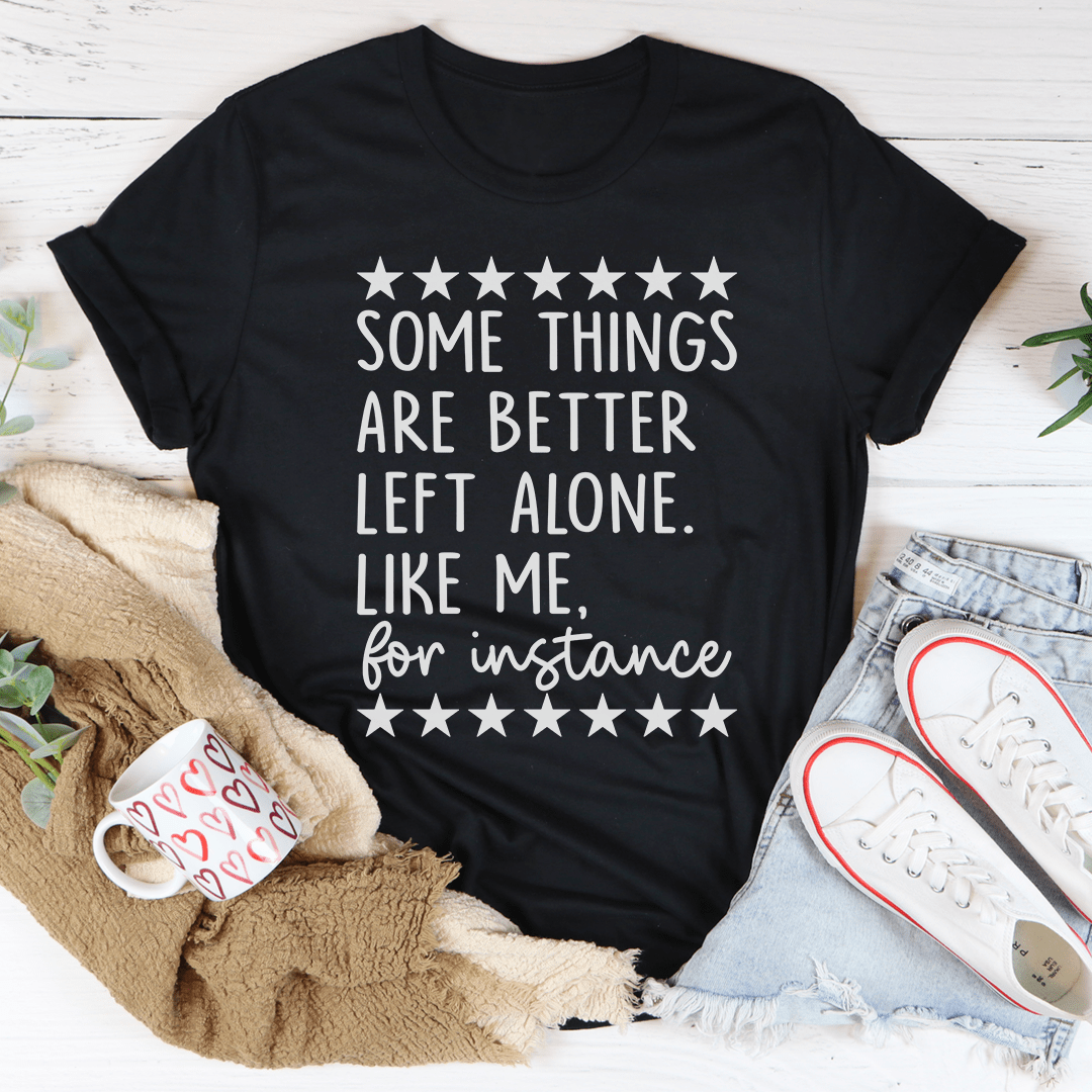 A stylish black t-shirt with the phrase 'Some Things Are Better Left Alone' printed on it, showcasing its soft fabric and durable stitching.