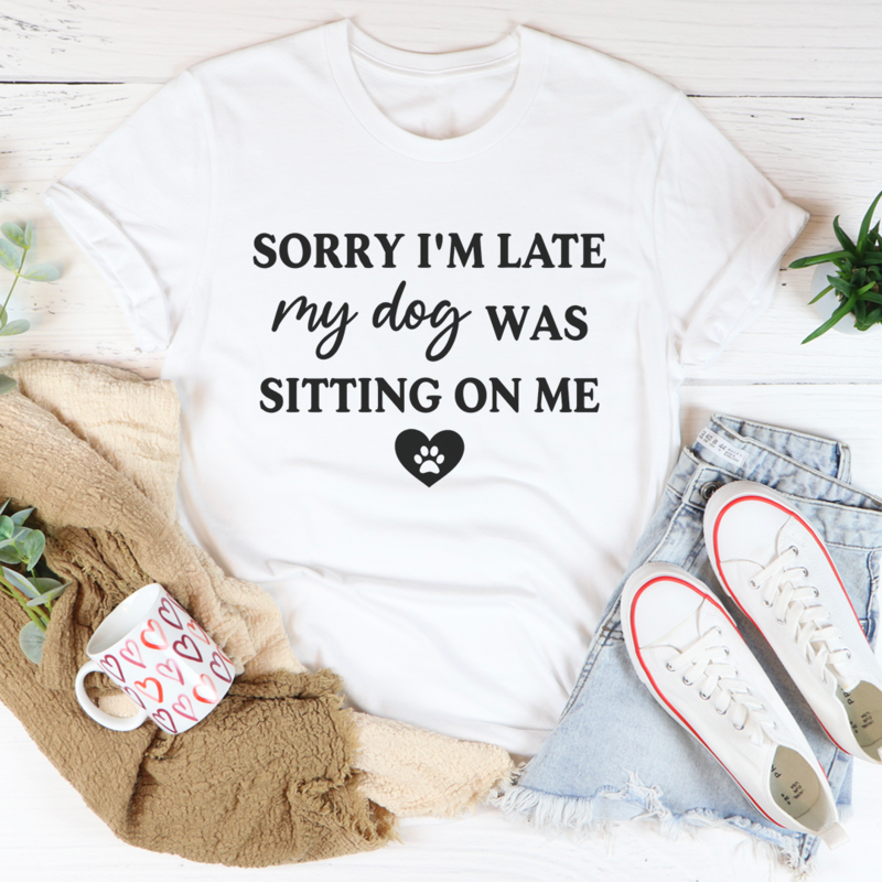 A comfortable and stylish t-shirt featuring the phrase 'Sorry I'm Late My Dog Was Sitting On Me', made from soft ring-spun cotton.