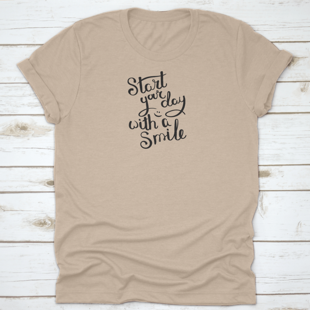 A motivational quote T-shirt featuring the phrase 'Start Your Day With A Smile', made from soft cotton fabric in various colors.