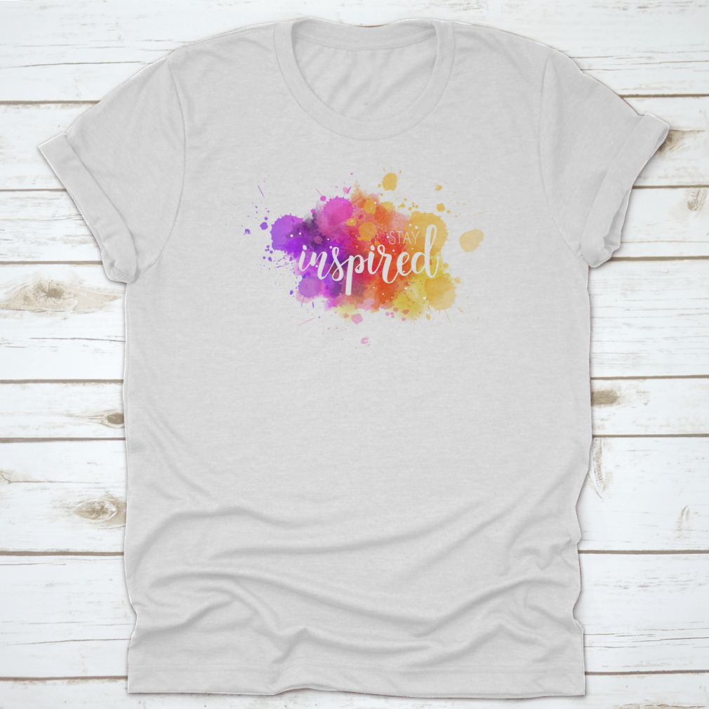 A stylish t-shirt featuring a hand lettering phrase on a vibrant watercolor background, made from 100% cotton for comfort.