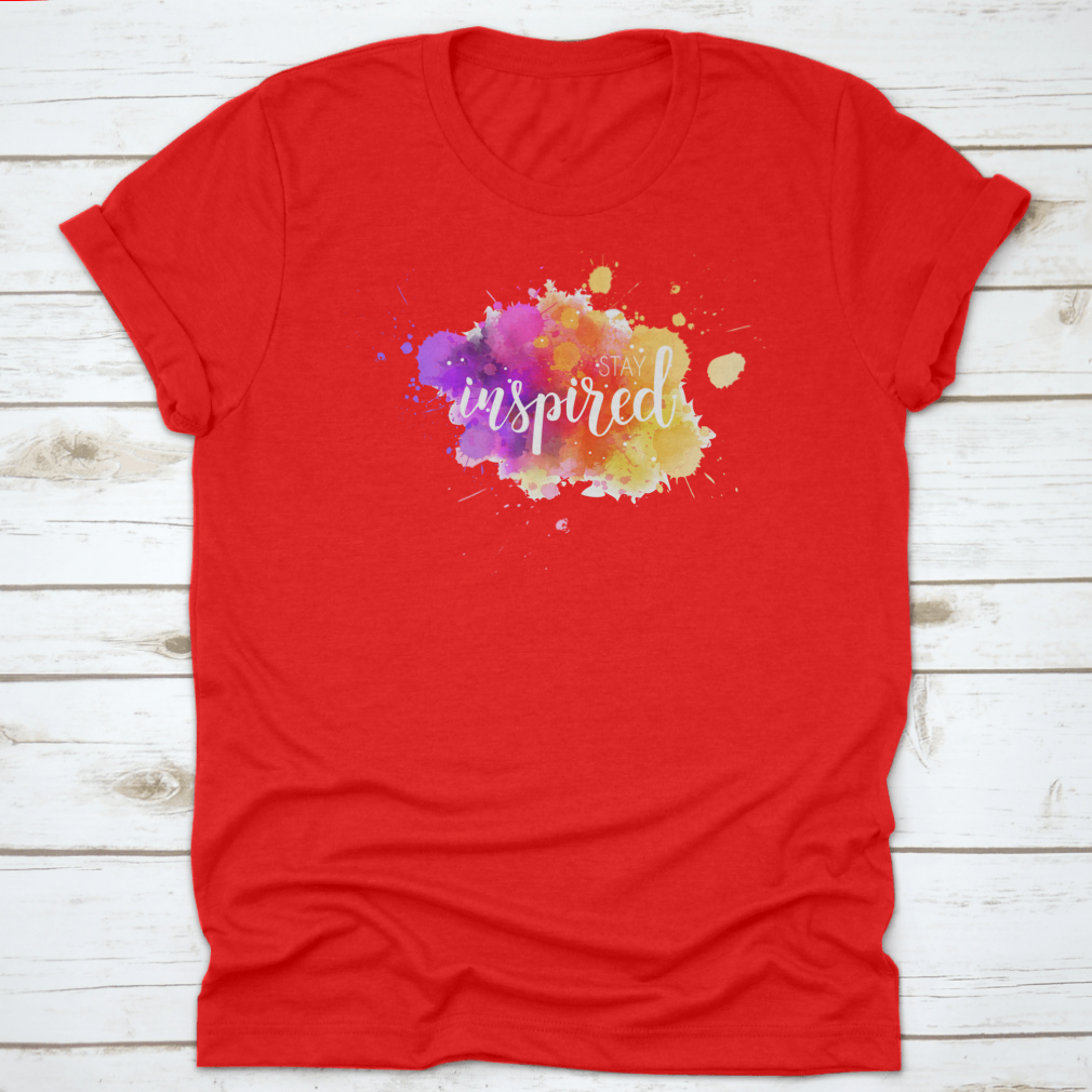 A stylish t-shirt featuring a hand lettering phrase on a vibrant watercolor background, made from 100% cotton for comfort.