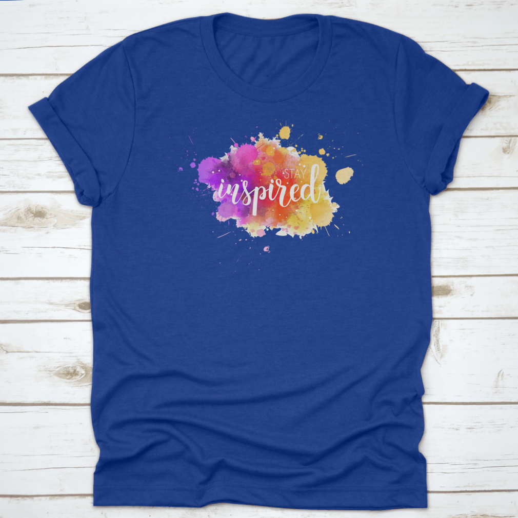A stylish t-shirt featuring a hand lettering phrase on a vibrant watercolor background, made from 100% cotton for comfort.