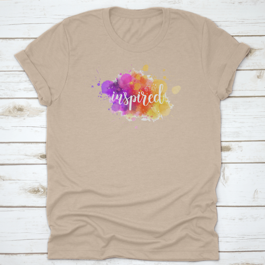 A stylish t-shirt featuring a hand lettering phrase on a vibrant watercolor background, made from 100% cotton for comfort.