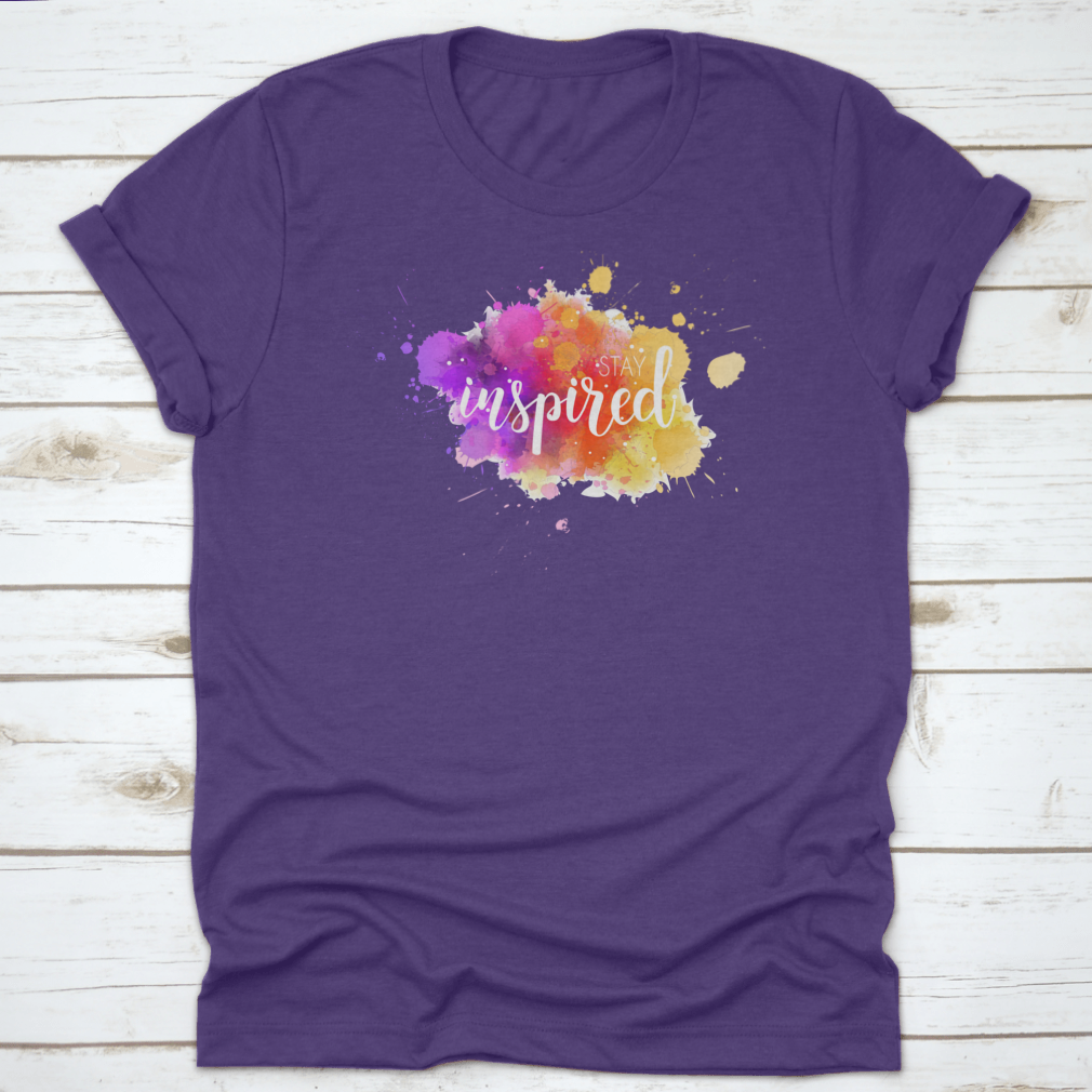 A stylish t-shirt featuring a hand lettering phrase on a vibrant watercolor background, made from 100% cotton for comfort.