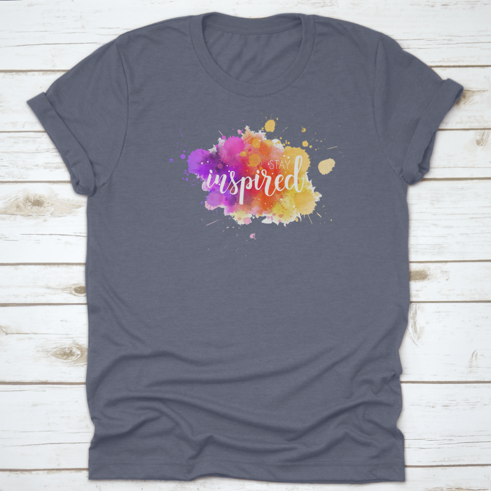 A stylish t-shirt featuring a hand lettering phrase on a vibrant watercolor background, made from 100% cotton for comfort.