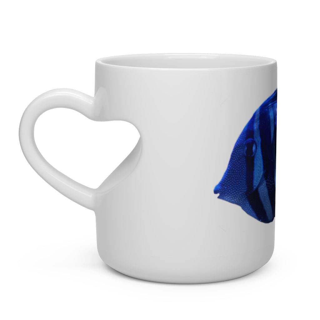 A white ceramic heart-shaped mug with a striped fish design and a heart-shaped handle, perfect for hot beverages.