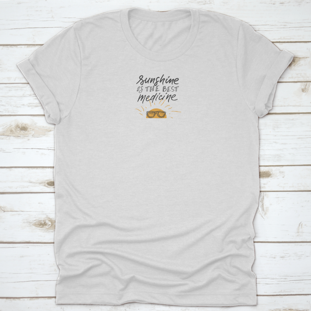 A stylish t-shirt featuring sunshine hand lettering quotes, showcasing a cheerful design on a soft fabric.