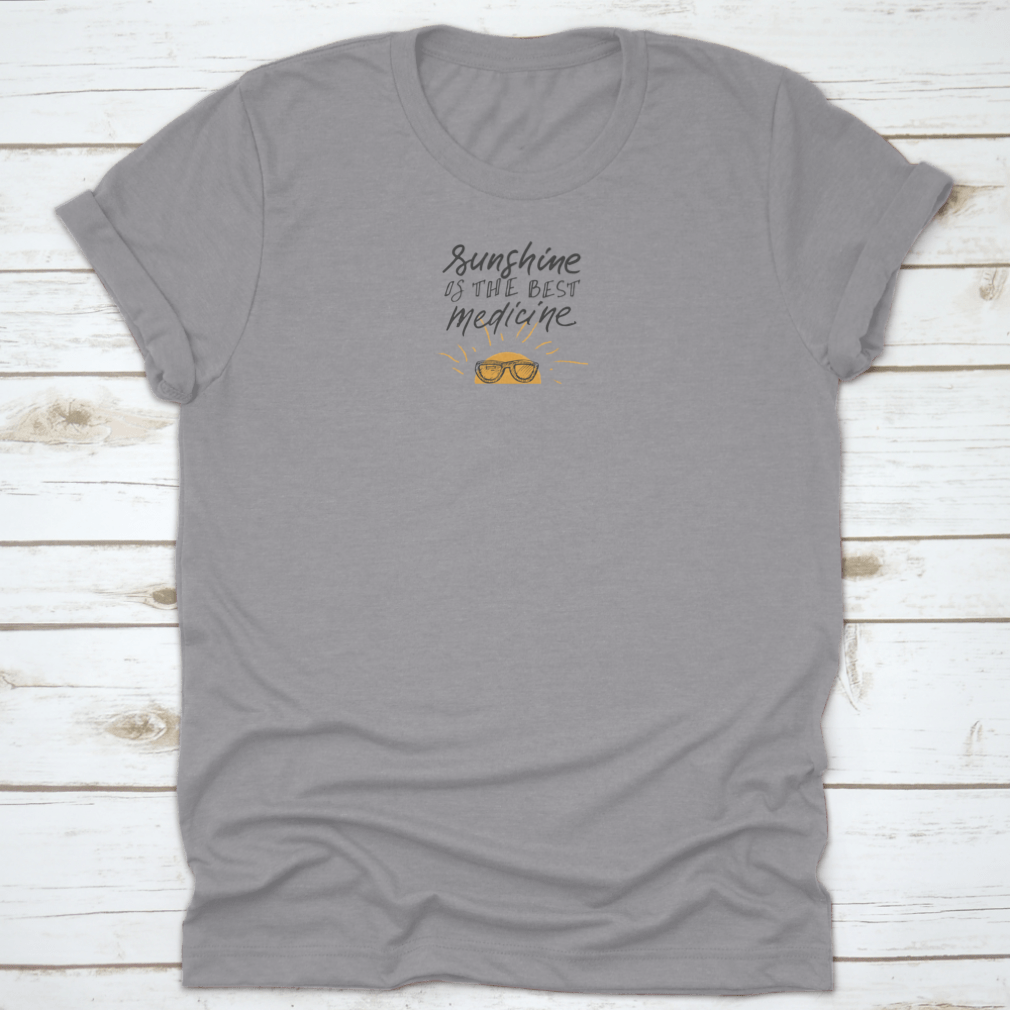 A stylish t-shirt featuring sunshine hand lettering quotes, showcasing a cheerful design on a soft fabric.