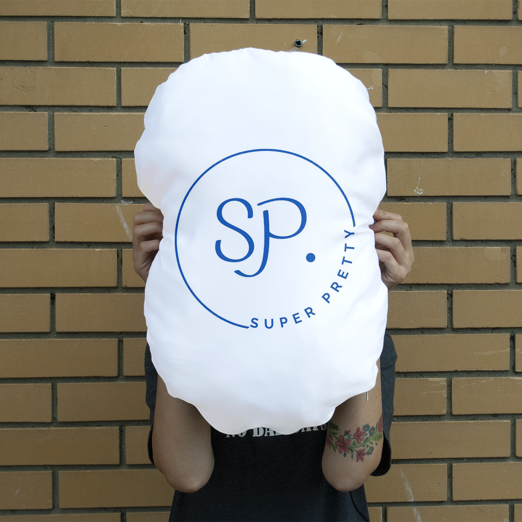 A giant personalized face cushion featuring a smiling face, showcasing vibrant colors and high-quality printing, perfect for home decor.