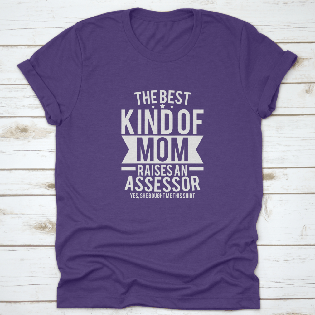 A stylish cotton shirt with the phrase 'The Best Kind Of Mom Raises An Assessor Yes, She Bought Me This Shirt' printed on it, showcasing a fun and loving message for mothers.