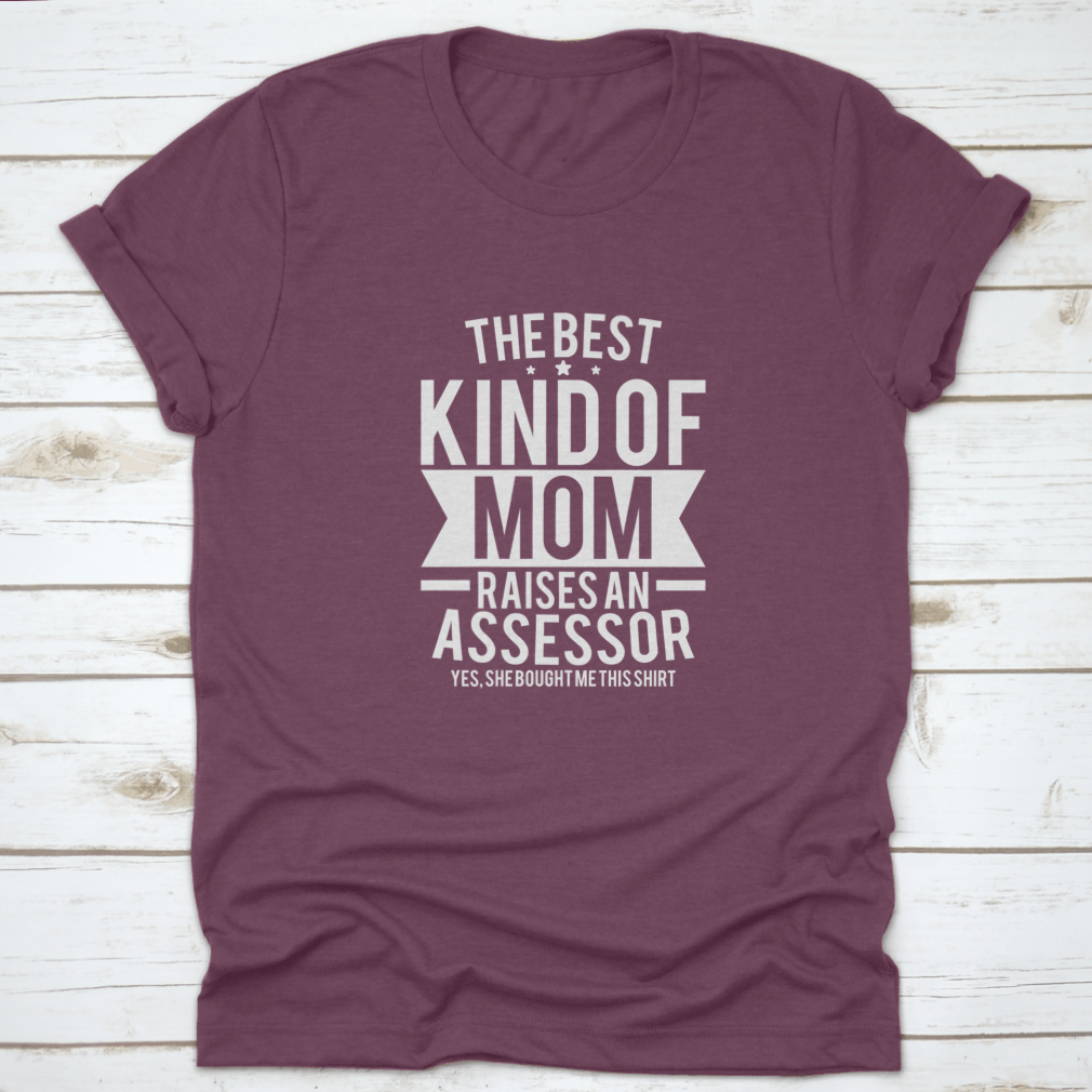 A stylish cotton shirt with the phrase 'The Best Kind Of Mom Raises An Assessor Yes, She Bought Me This Shirt' printed on it, showcasing a fun and loving message for mothers.