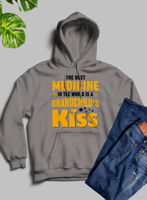 Cozy hoodie featuring the phrase 'The Best Medicine In The World Is A Grandchild's Kiss', designed for warmth and comfort.