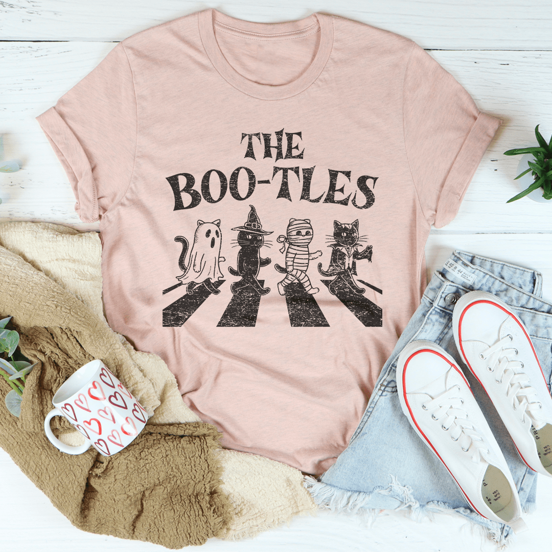 The Boo-tless Cat Tee, a unisex short sleeve t-shirt made from soft cotton, featuring a vibrant cat design, perfect for casual wear.