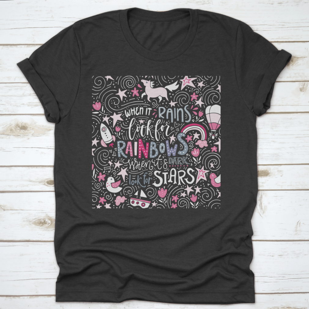 A comfortable t-shirt featuring the inspirational quote 'When It Rains Look For Rainbows' in a stylish hand-drawn vector design.