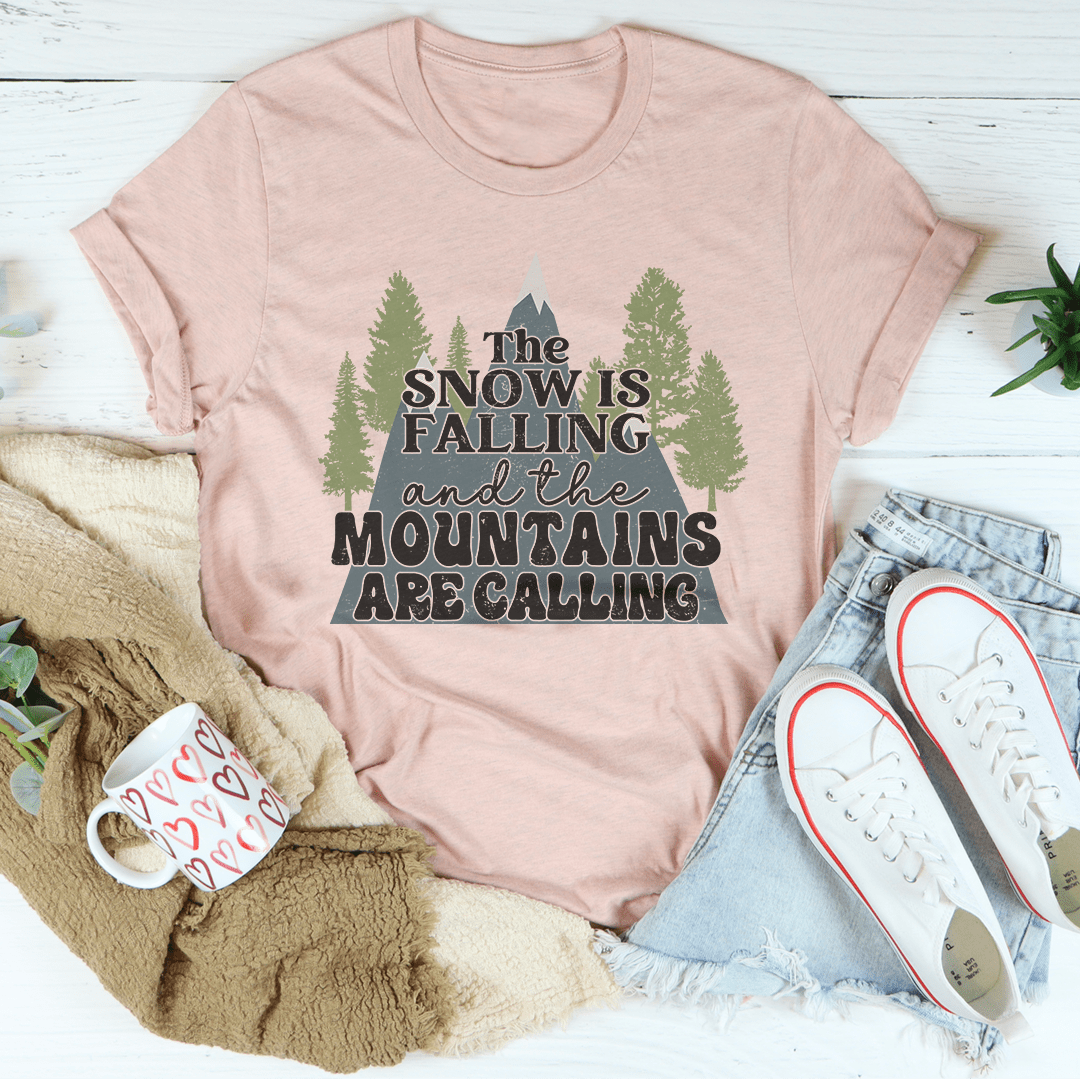 A festive tee featuring a snowy mountain design, made from 100% soft cotton, perfect for holiday celebrations.