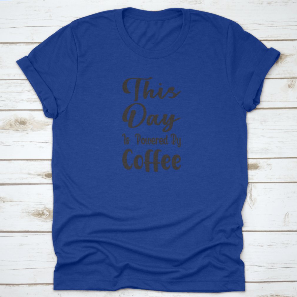 A stylish cotton t-shirt featuring the quote 'This Day Is Powered By Coffee' in a modern font, perfect for coffee lovers.