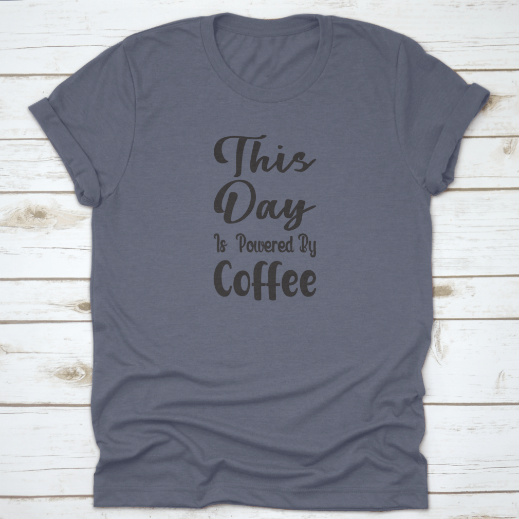 A stylish cotton t-shirt featuring the quote 'This Day Is Powered By Coffee' in a modern font, perfect for coffee lovers.