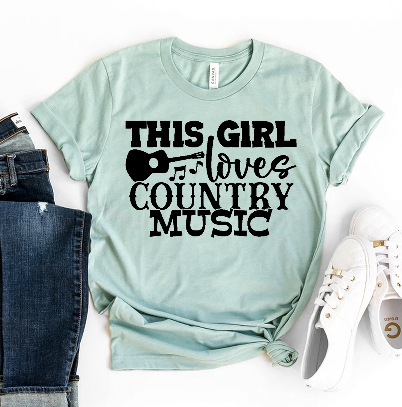 A stylish T-shirt featuring the phrase 'This Girl Loves Country Music' printed in a vibrant design, made from soft ring spun cotton.