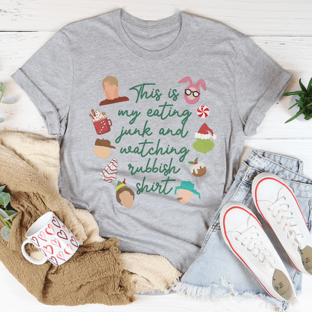 A festive Christmas-themed tee shirt made of soft cotton, featuring a humorous slogan about eating junk food and watching shows.