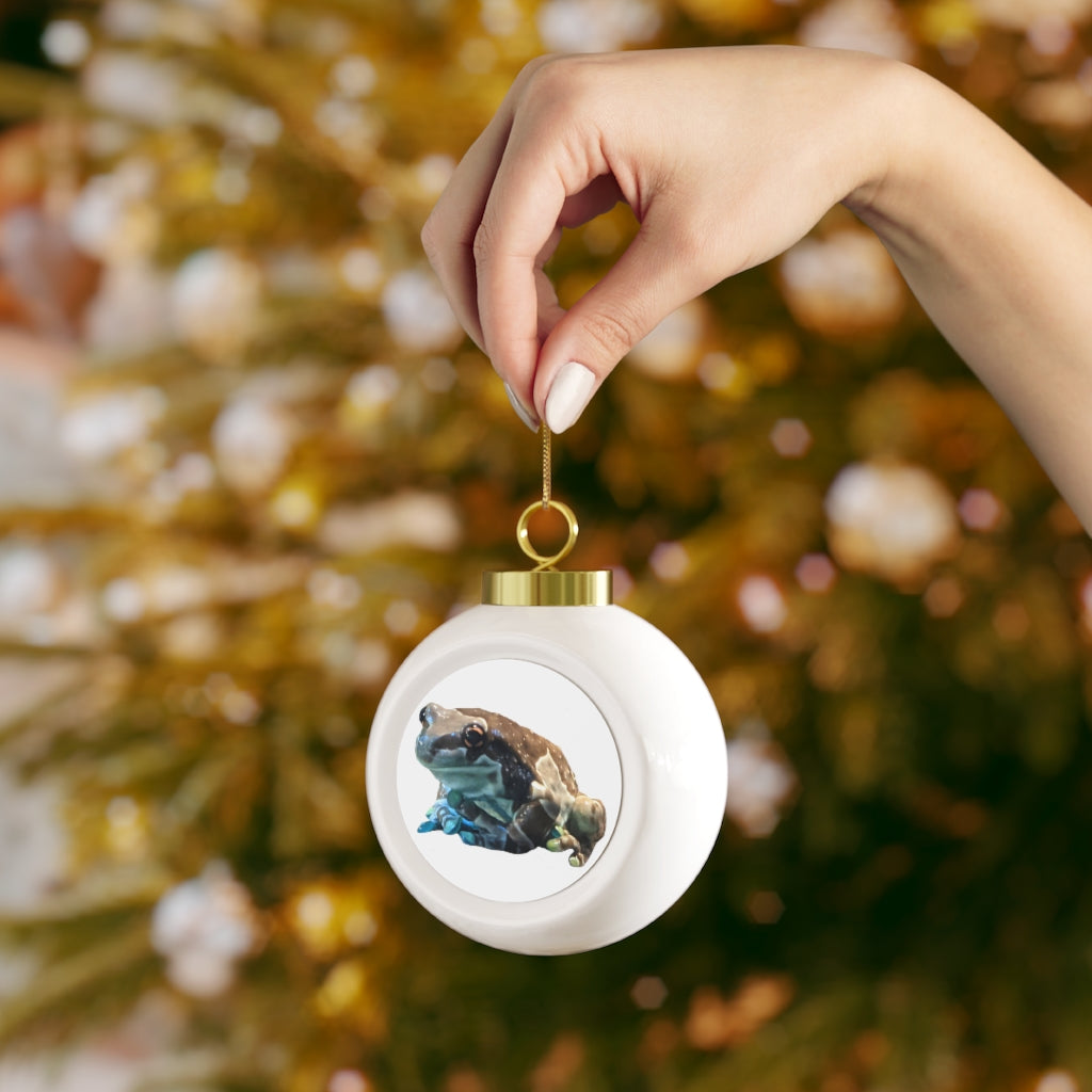 A beautifully designed Toad Christmas Ball Ornament featuring a glossy finish and gold ribbon, perfect for holiday decorating.