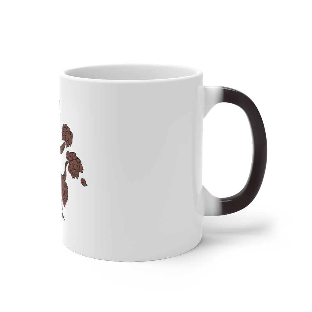 A white ceramic mug with a tree design that changes color when filled with hot liquid, showcasing its unique feature.