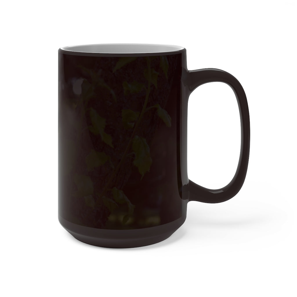 A color-changing ceramic mug featuring a tree stump and green leaves design, showcasing its vibrant colors when filled with hot liquid.