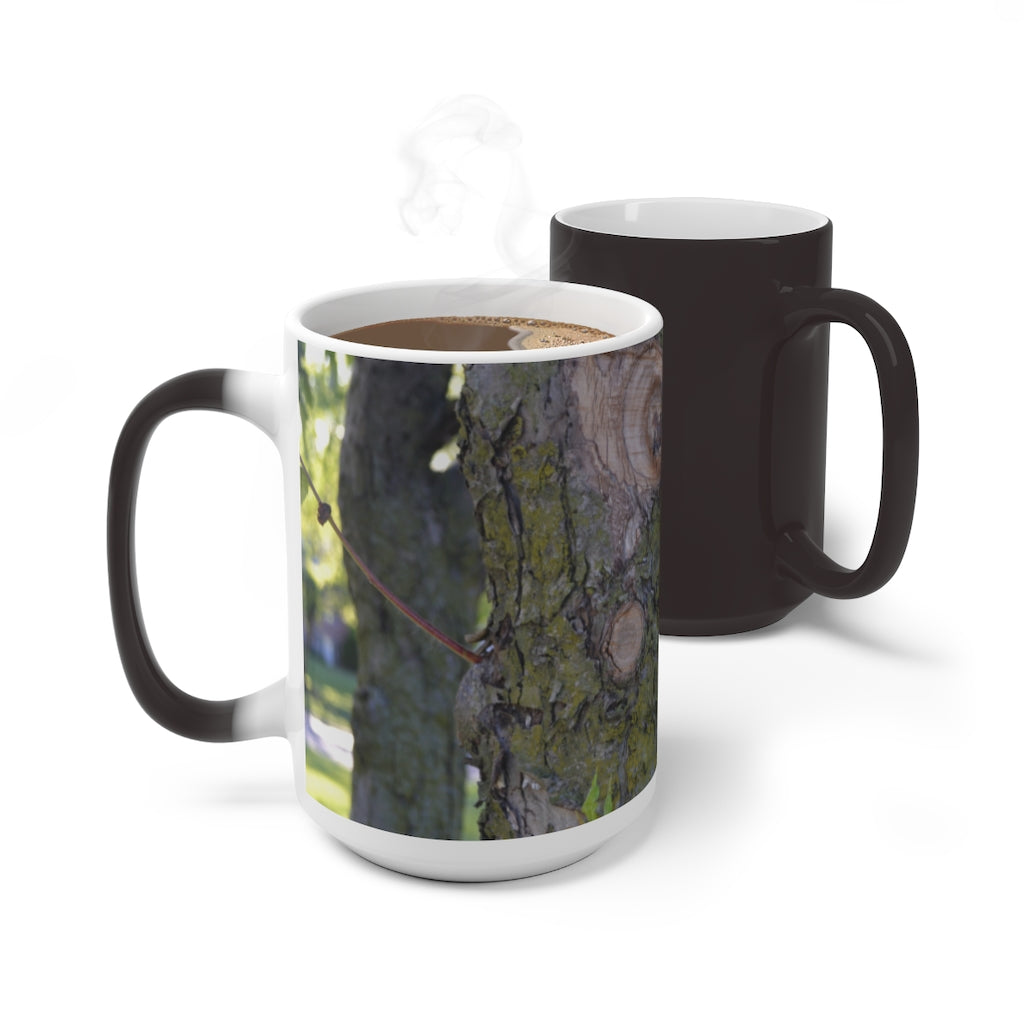 A color-changing ceramic mug featuring a tree stump and green leaves design, showcasing its vibrant colors when filled with hot liquid.