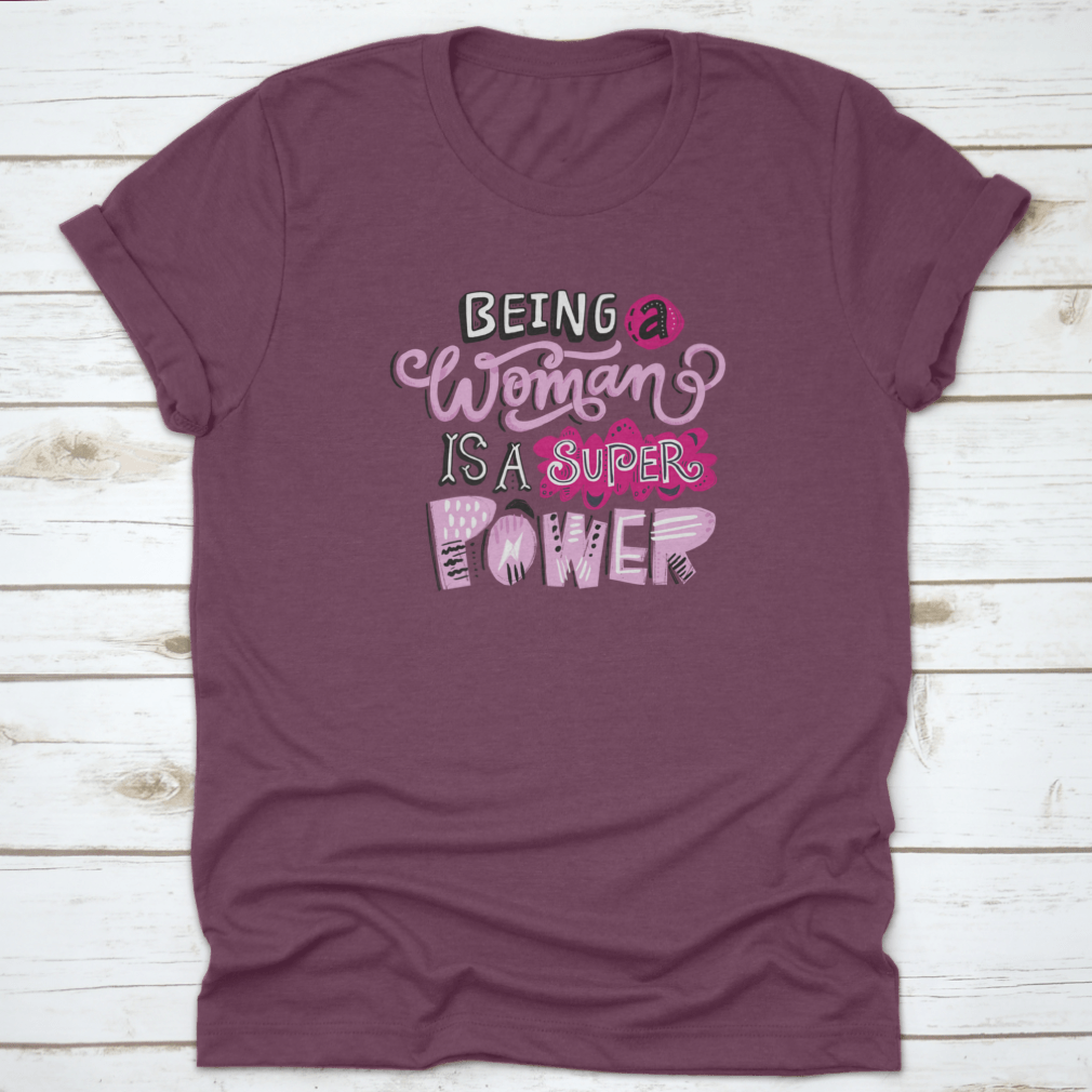 Unique hand-drawn lettering quote t-shirt featuring the phrase 'Being A Woman Is A', showcasing its stylish design and comfortable fit.