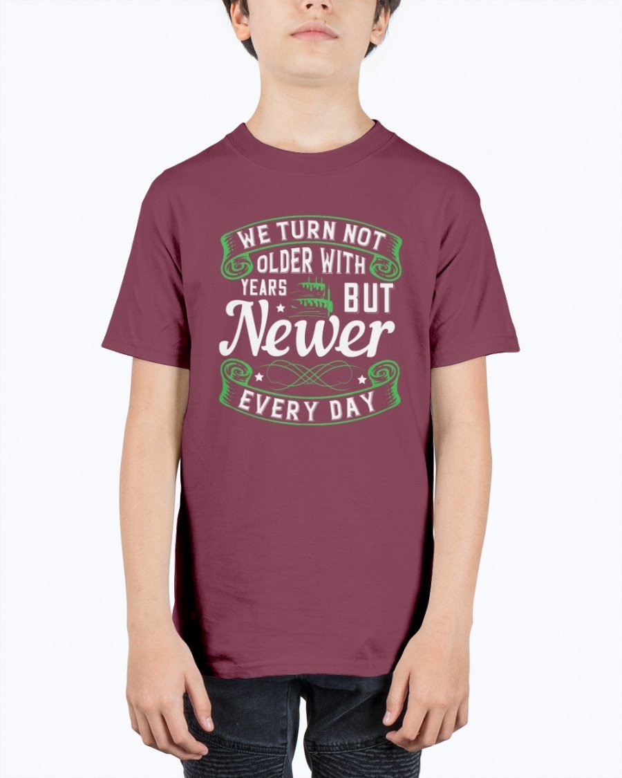 A stylish unisex birthday t-shirt featuring the quote 'We turn not older with years, but newer every day' in a vibrant design.