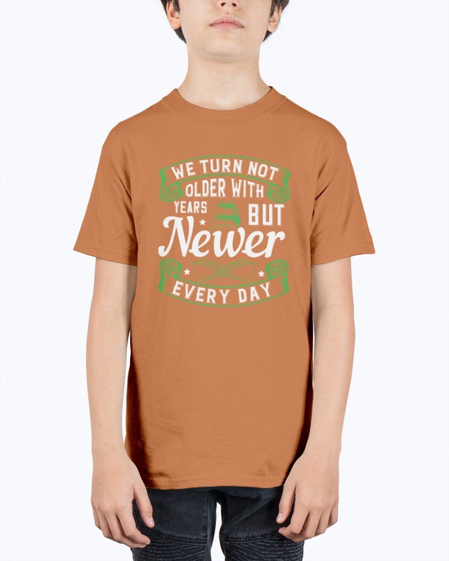 A stylish unisex birthday t-shirt featuring the quote 'We turn not older with years, but newer every day' in a vibrant design.