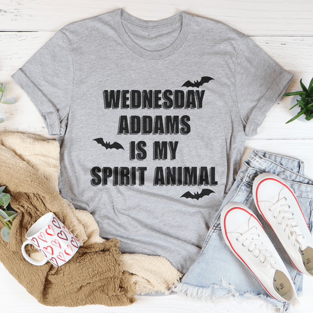 A black tee featuring the phrase 'Wednesday Addams Is My Spirit Animal' in a spooky font, perfect for Halloween.
