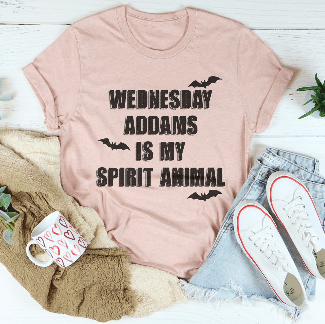 A black tee featuring the phrase 'Wednesday Addams Is My Spirit Animal' in a spooky font, perfect for Halloween.