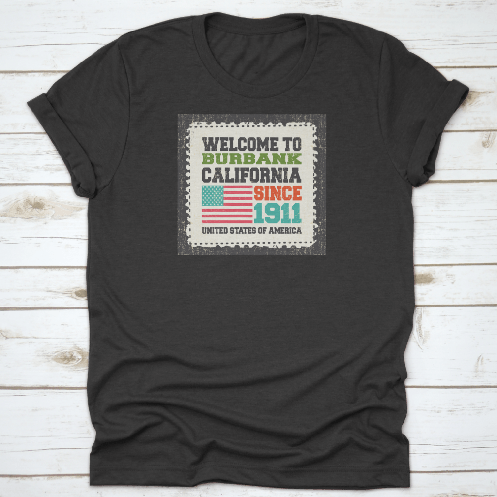 A classic cotton t-shirt featuring the phrase 'Welcome To Burbank, State California. Since 1911' with an American flag design, showcasing its comfortable fit and quality fabric.