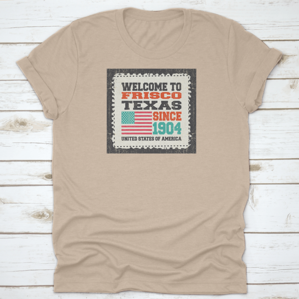 A classic t-shirt featuring the American flag and the text 'Welcome To Frisco, State Texas. Since 1904', made from high-quality cotton.