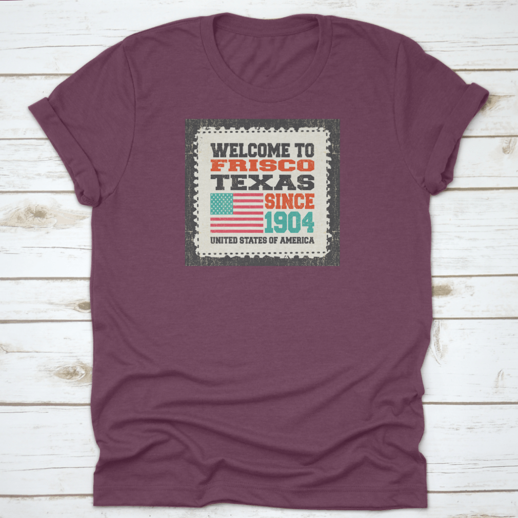 A classic t-shirt featuring the American flag and the text 'Welcome To Frisco, State Texas. Since 1904', made from high-quality cotton.