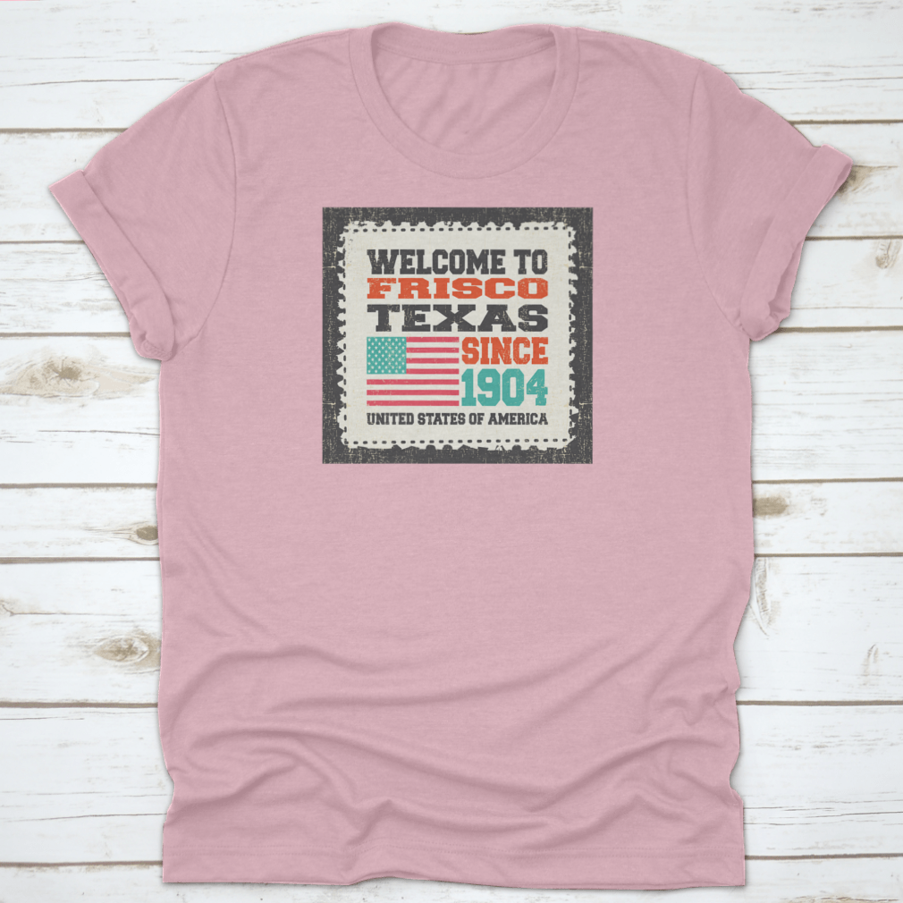 A classic t-shirt featuring the American flag and the text 'Welcome To Frisco, State Texas. Since 1904', made from high-quality cotton.