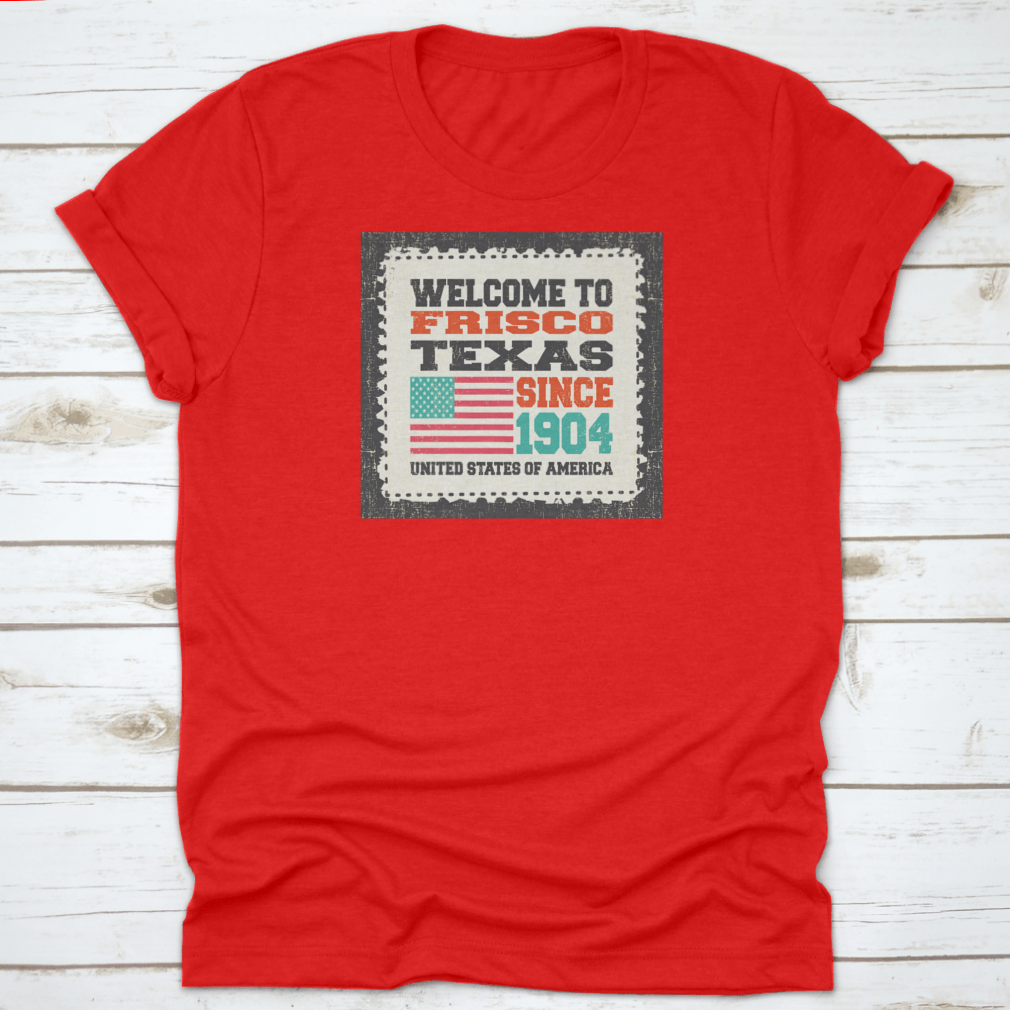 A classic t-shirt featuring the American flag and the text 'Welcome To Frisco, State Texas. Since 1904', made from high-quality cotton.