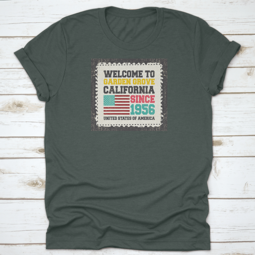 A classic t-shirt featuring the American flag and the text 'Welcome To Garden Grove, California' since 1956, showcasing a vibrant design.