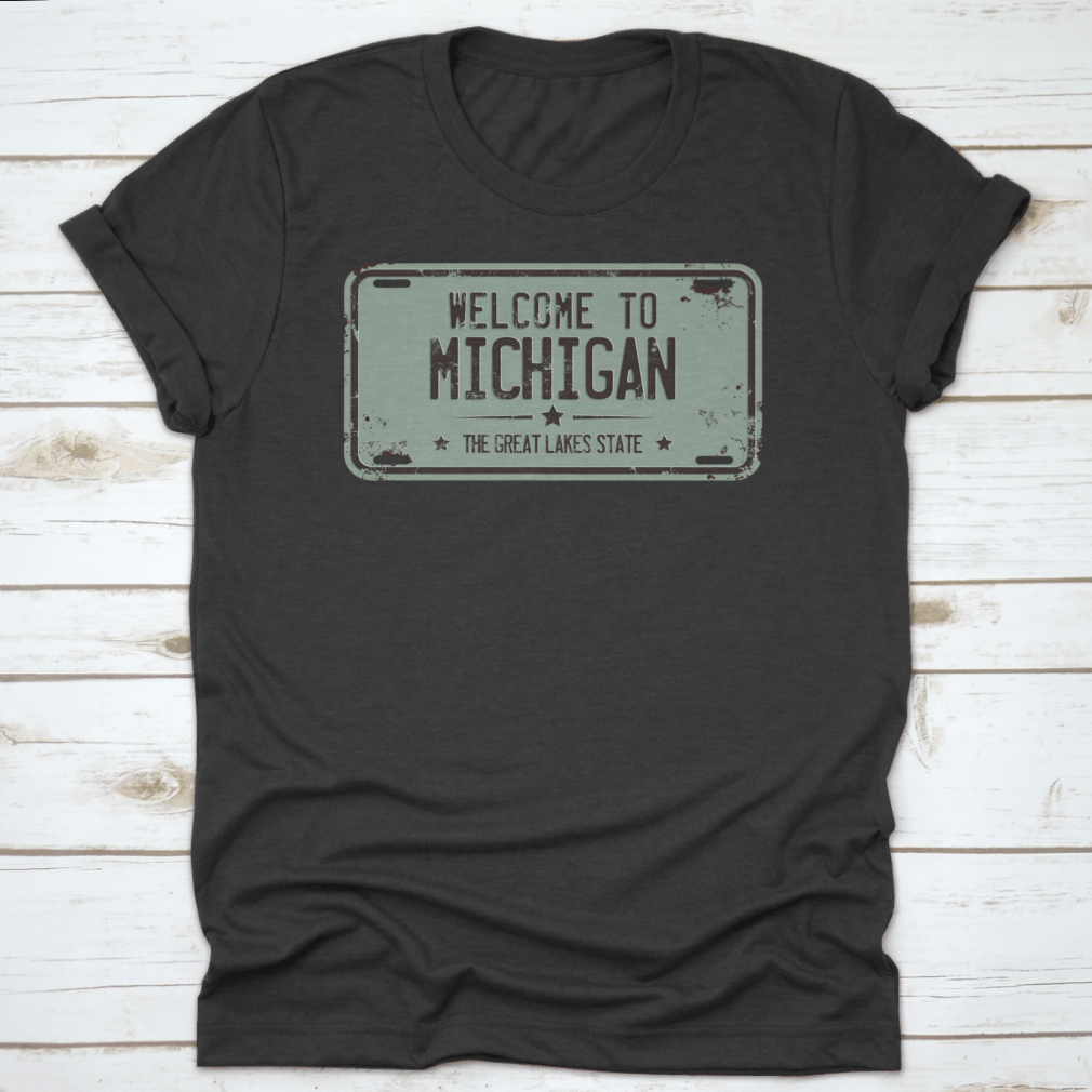 A stylish cotton t-shirt featuring a damaged license plate design with the message 'Welcome To Michigan', showcasing its comfortable fit and quality fabric.